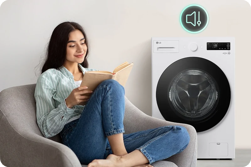 LG washing machine operating quietly while a woman reads nearby.