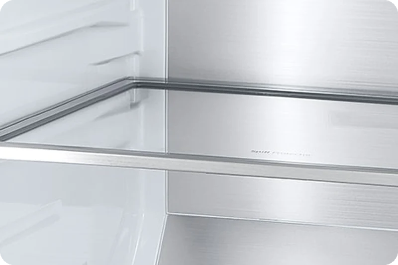 Diagonal view of metallic paneling inside the refrigerator.