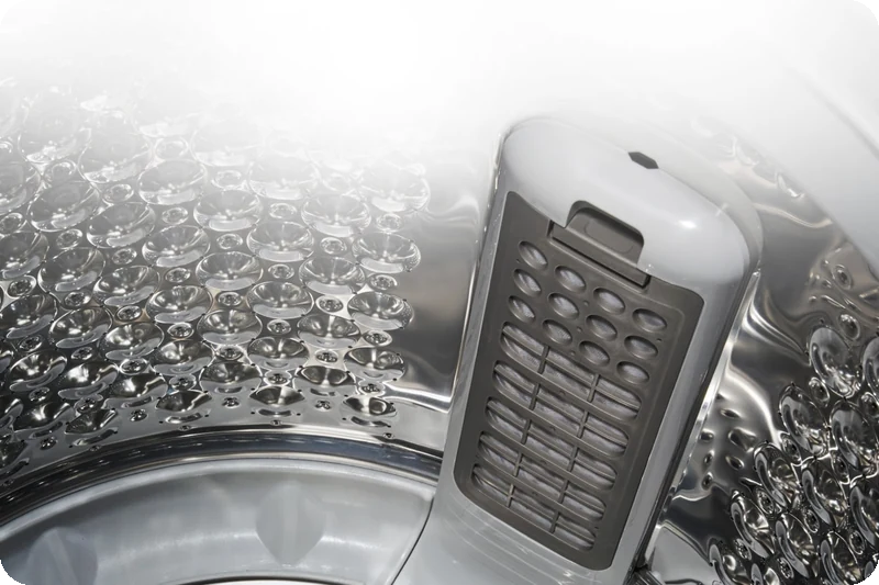 LG top-load washer drum showing its large lint filter and semi-stainless-steel design.