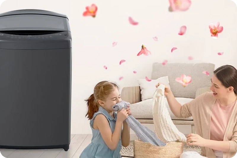 Mother and daughter enjoying freshly washed towels beside the LG top-load washer with Scent+.